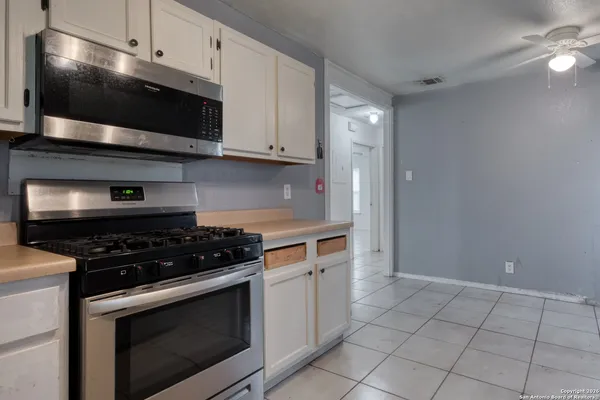 a kitchen with stainless steel appliances granite countertop a stove and a microwave