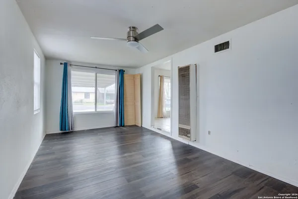 wooden floor in an empty room with a window