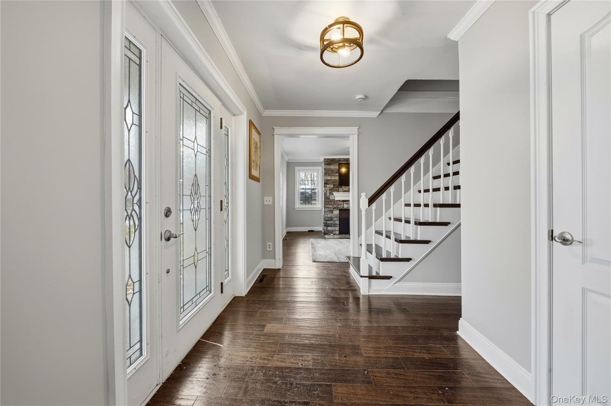 293 Highway 94 Warwick, NY 10990 - Photo 3 of 20 Entryway with crown molding, stairs, and dark wood finished floors