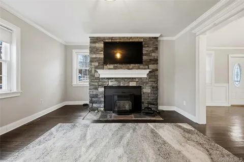a living room with a fireplace and a flat screen tv