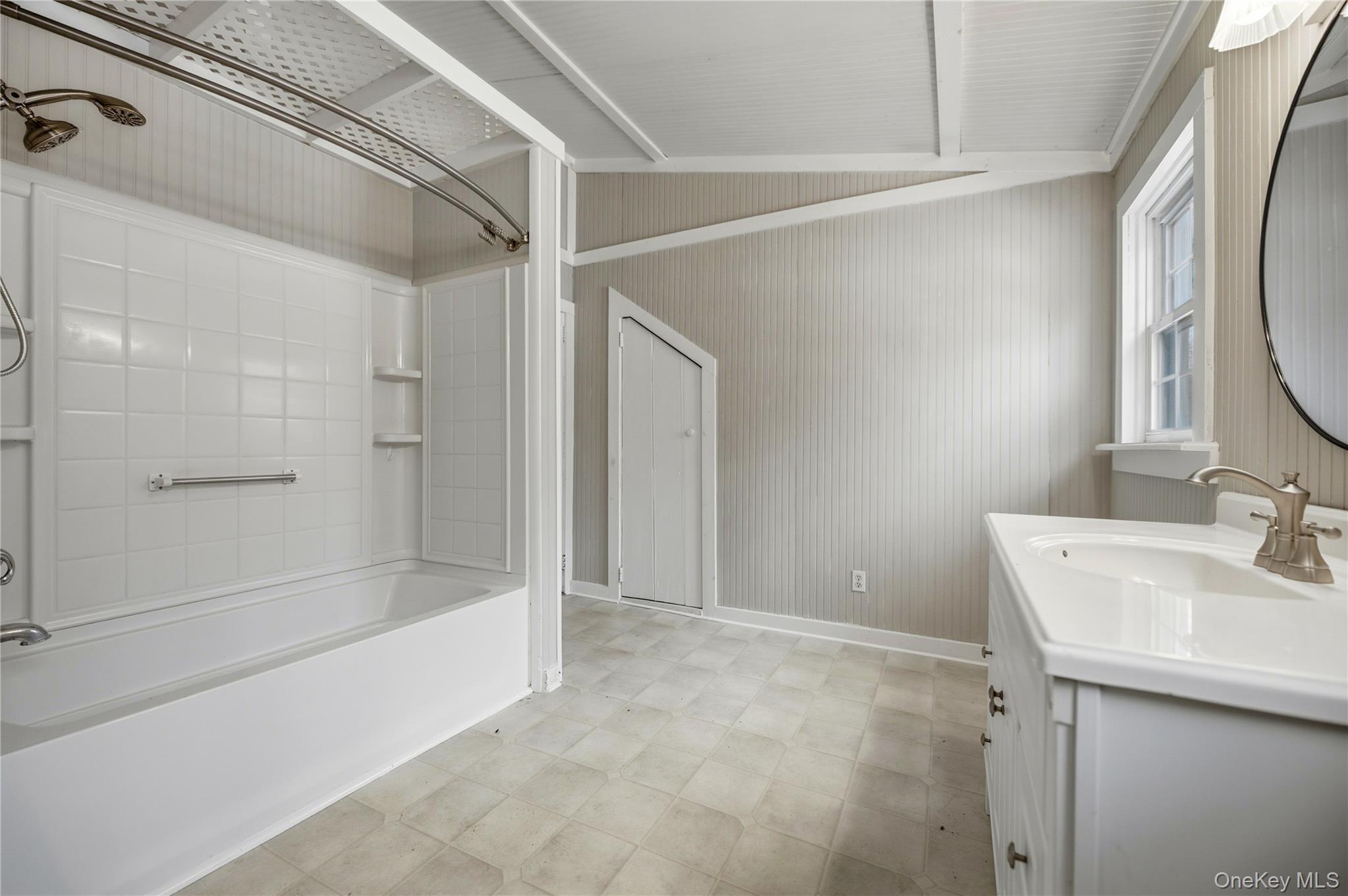 293 Highway 94 Warwick, NY 10990 - Photo 9 of 20 Full bath with bathing tub / shower combination, vanity, vaulted ceiling, and light flooring