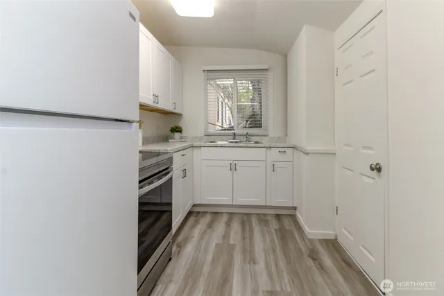 a kitchen with a sink stove and cabinets