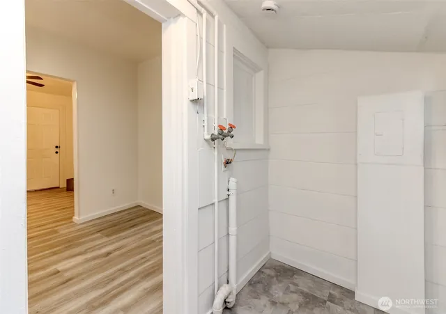 a view of a hallway with wooden floor and closet area