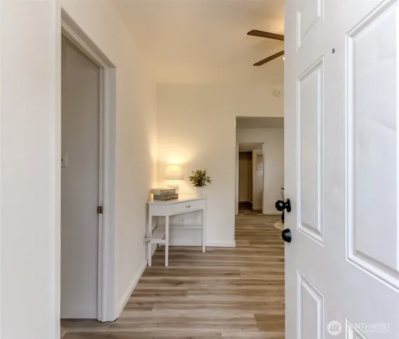 a view of a hallway view with wooden floor and staircase
