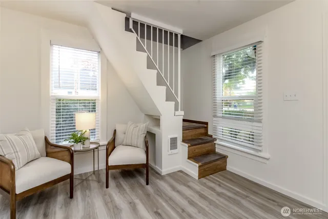 a living room with furniture and a stairs