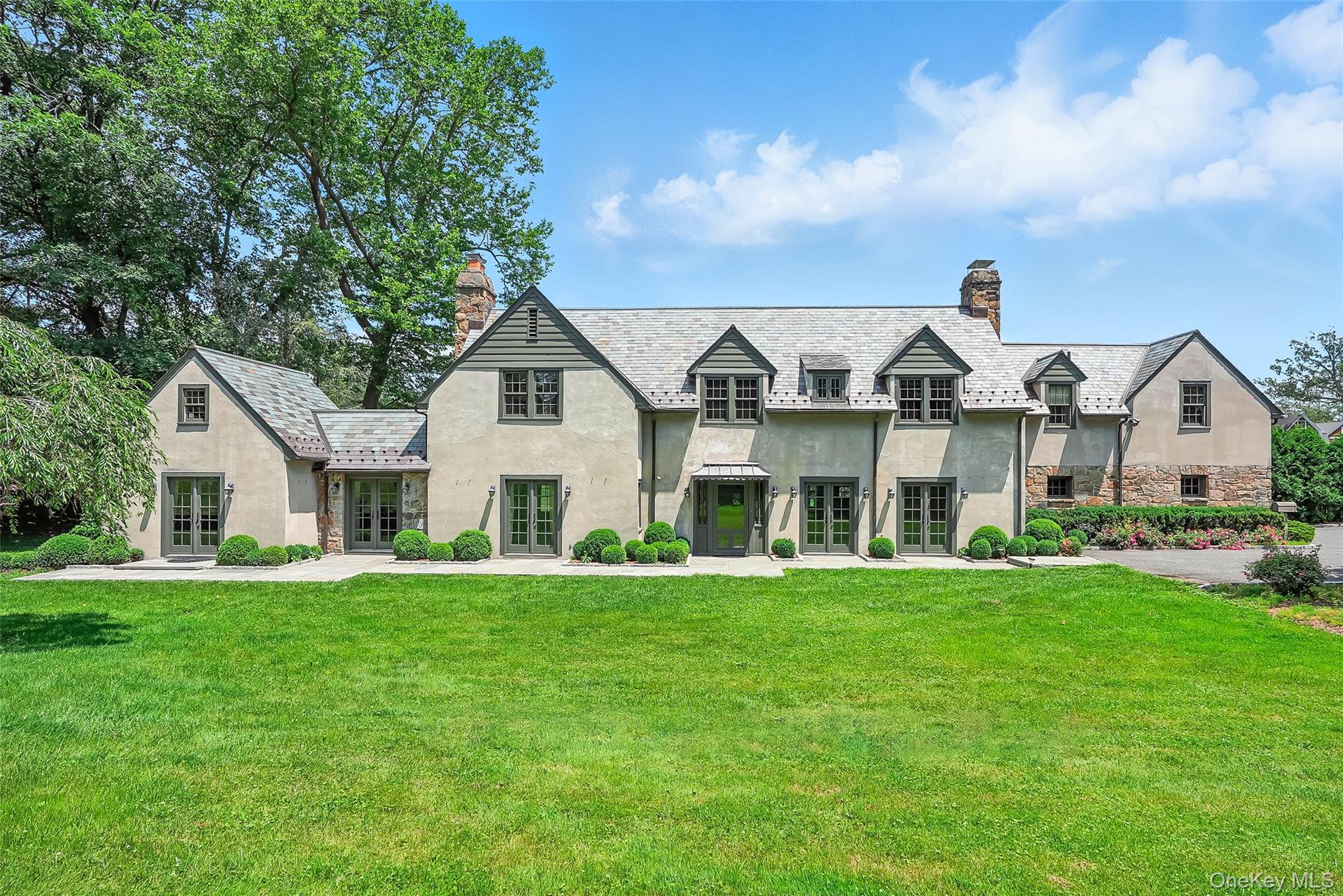 a front view of a house with a garden