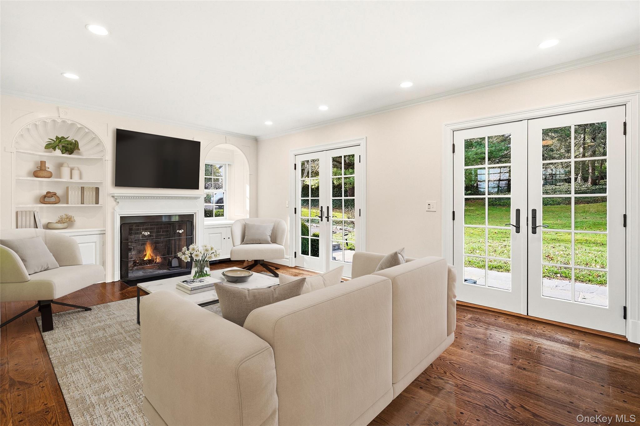 6 Club Road Rye, NY 10580 - Photo 5 of 26 a living room with furniture a flat screen tv and a fireplace