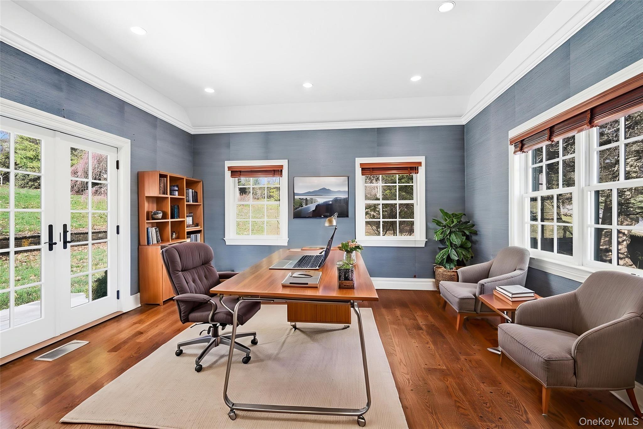 6 Club Road Rye, NY 10580 - Photo 10 of 26 a living room with furniture two large window and wooden floor