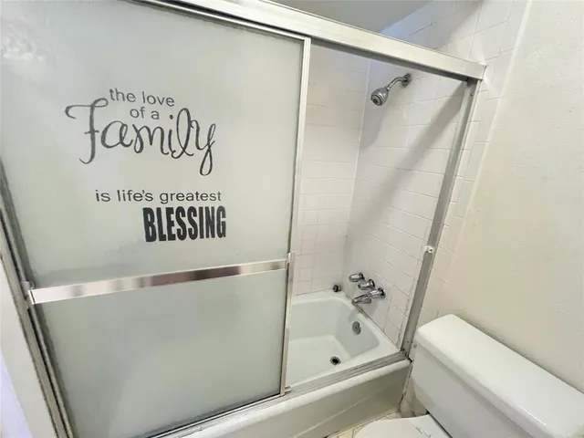 a bathroom with a bathtub and shower