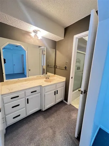 a bathroom with a double vanity sink and mirror