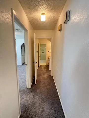 a view of hallway with wooden floor