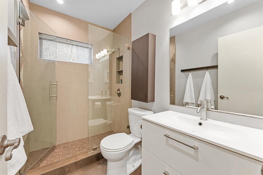 2451 Southwest 82nd Avenue, Unit 310 Davie, FL 33324 - Photo 12 of 21 a bathroom with a sink a toilet and a large mirror