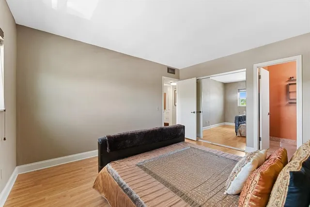 a bedroom with a bed and a mirror