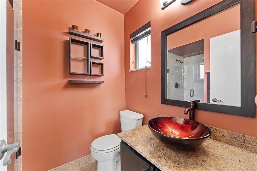 2451 Southwest 82nd Avenue, Unit 310 Davie, FL 33324 - Photo 15 of 21 a bathroom with a granite countertop toilet and a mirror