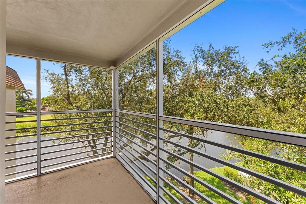 2451 Southwest 82nd Avenue, Unit 310 Davie, FL 33324 - Photo 18 of 21 a view of a balcony with floor to ceiling windows and wooden fence
