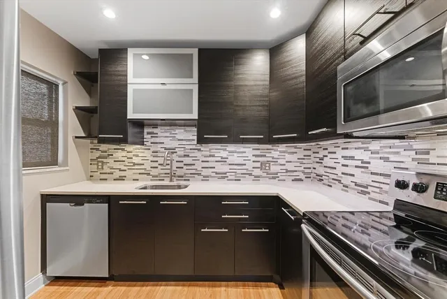 a kitchen with stainless steel appliances granite countertop a stove and a sink