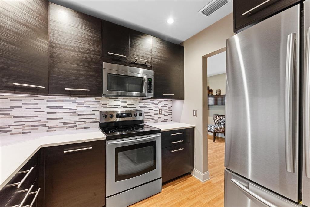 2451 Southwest 82nd Avenue, Unit 310 Davie, FL 33324 - Photo 5 of 21 a kitchen with stainless steel appliances a stove microwave and refrigerator