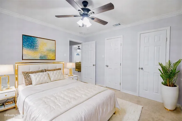 a bedroom with a large bed and a chandelier