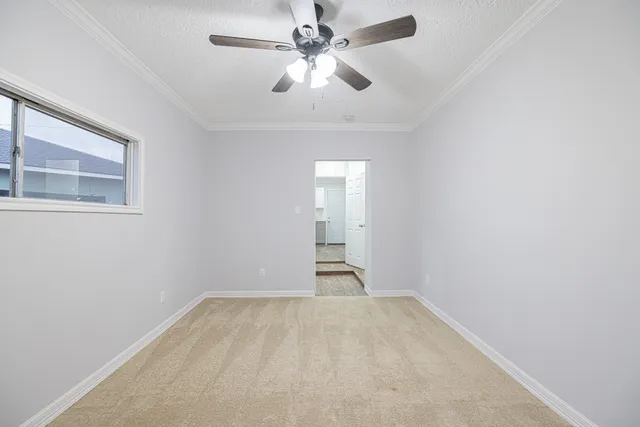 wooden floor in an empty room with a chandelier fan