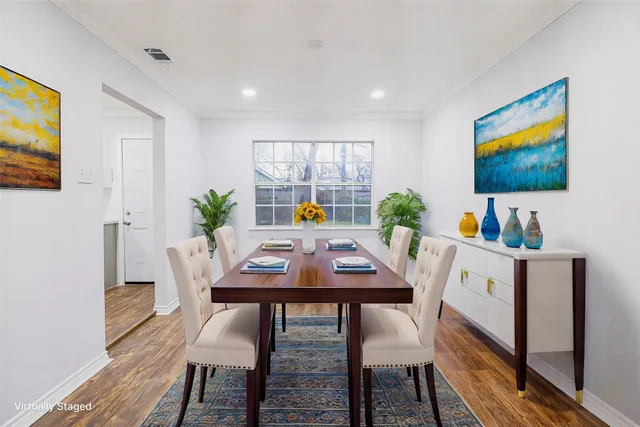 a view of a dining room with furniture and a potted plant