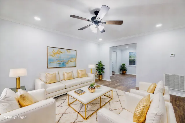 a living room with furniture and a chandelier