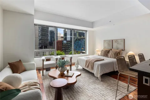 a bedroom with furniture and a large window