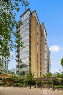 a aerial view of multi story residential apartment building with a yard and potted plants