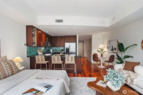 a bedroom with furniture and a large window