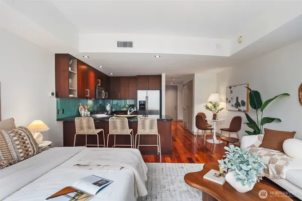 a bedroom with furniture and a large window