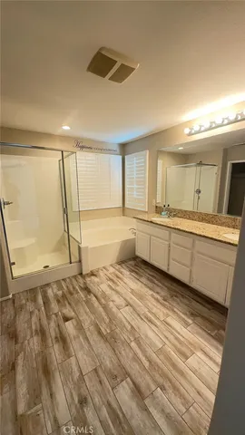a view of a hallway with wooden floor and a living room
