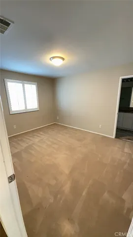 an empty room with a empty space and windows