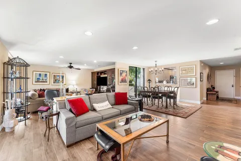 a kitchen with white cabinets and sink