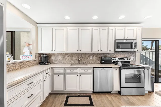 a kitchen with a table chairs stove and cabinets