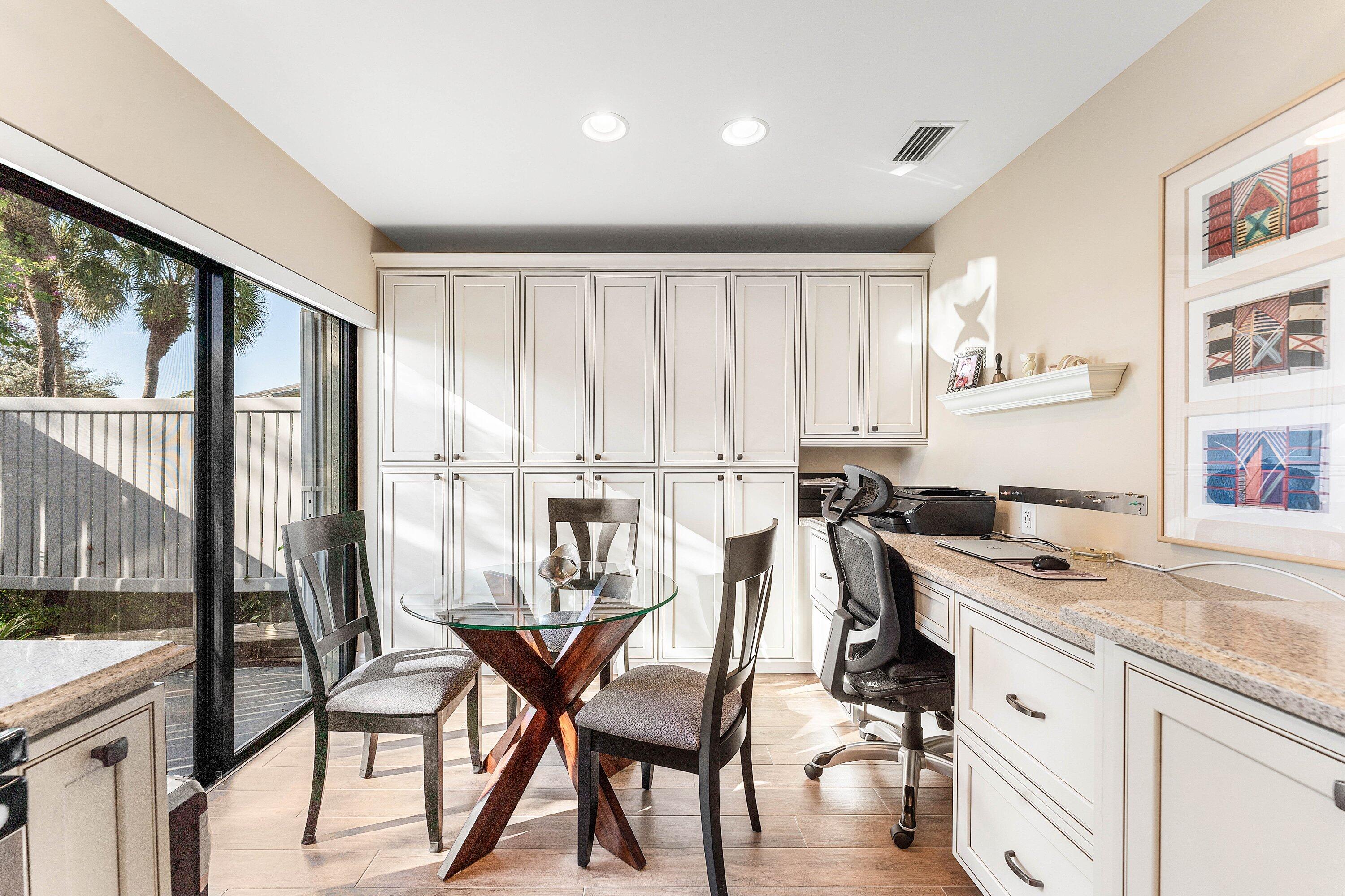 67 Eastgate Drive, Unit C Boynton Beach, FL 33436 - Photo 21 of 62 a kitchen with a table chairs stove and cabinets