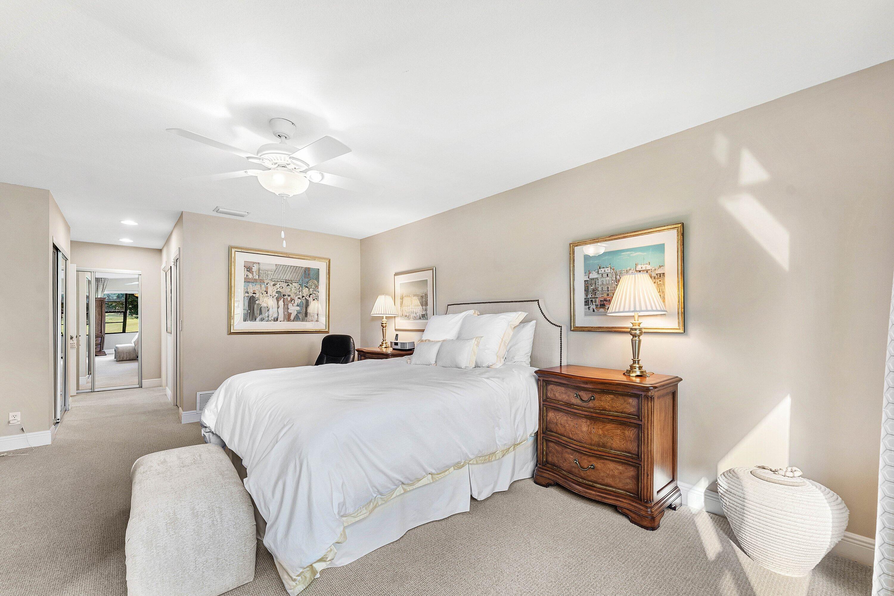 67 Eastgate Drive, Unit C Boynton Beach, FL 33436 - Photo 29 of 62 a bedroom with a bed and a chandelier