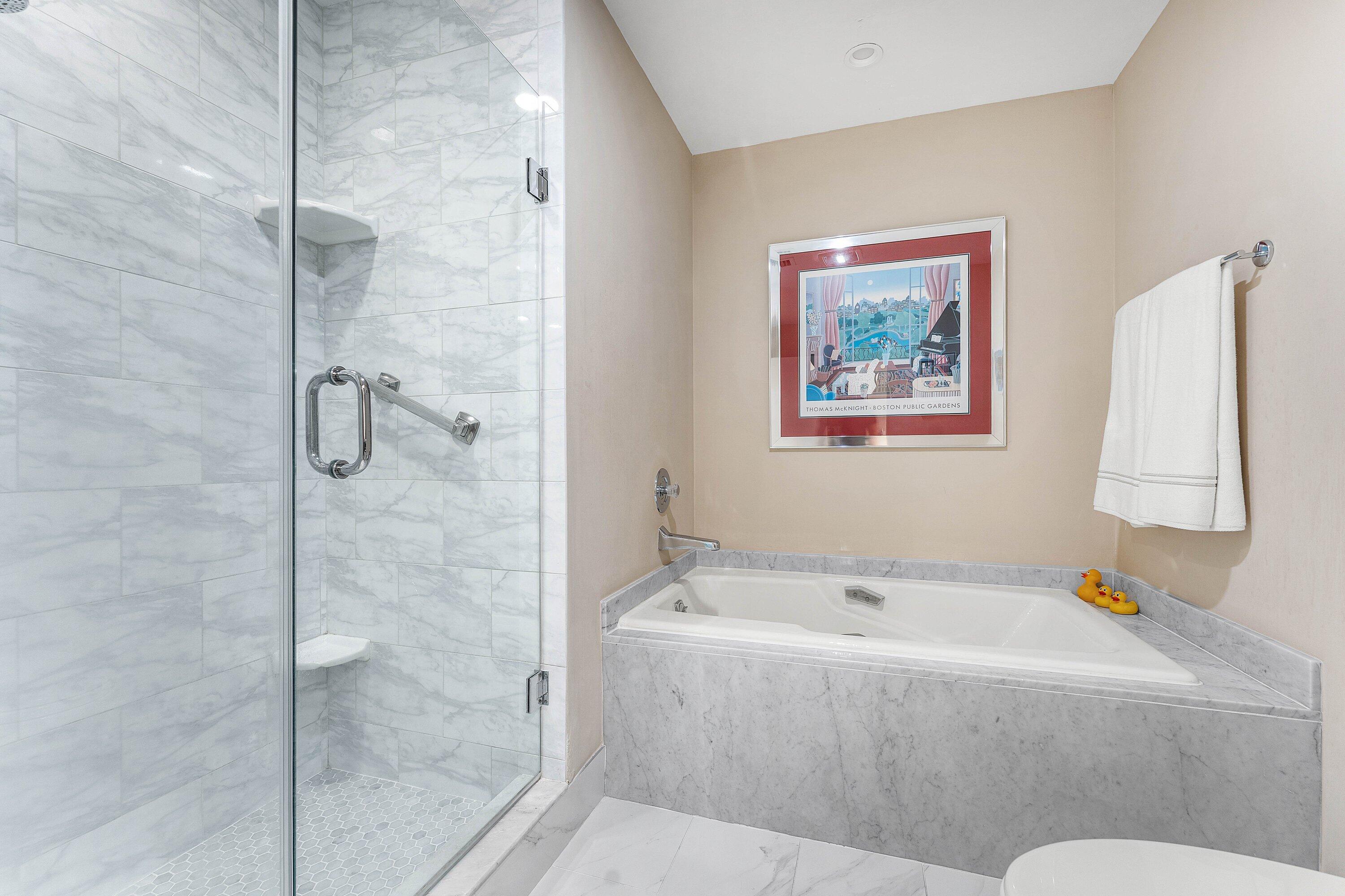 67 Eastgate Drive, Unit C Boynton Beach, FL 33436 - Photo 33 of 62 a bath tub sitting next to a bathroom