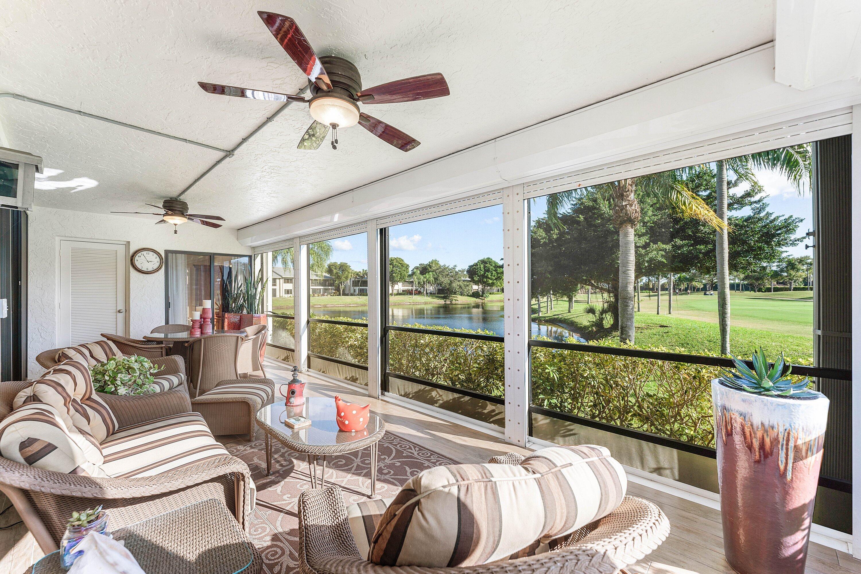 67 Eastgate Drive, Unit C Boynton Beach, FL 33436 - Photo 35 of 62 a living room with furniture and a floor to ceiling window