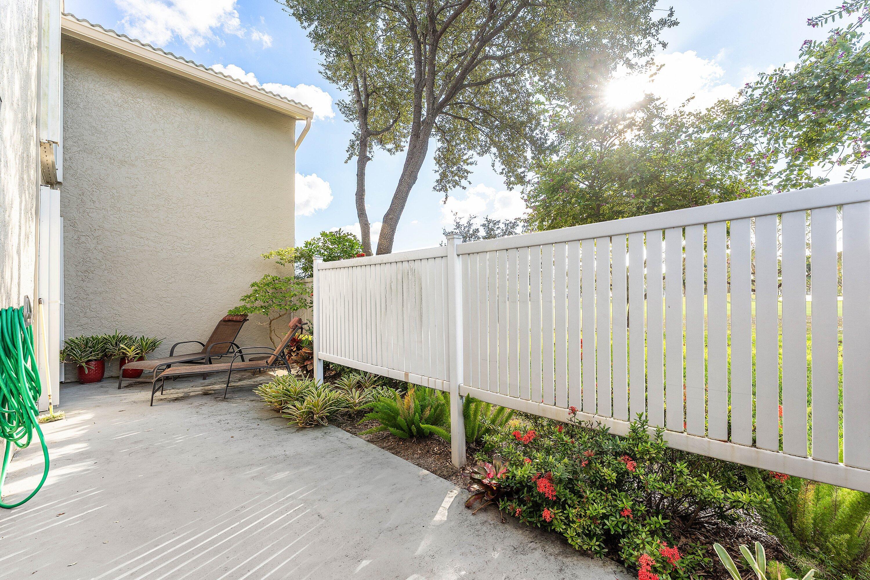 67 Eastgate Drive, Unit C Boynton Beach, FL 33436 - Photo 37 of 62 a wooden fence with some potted plants