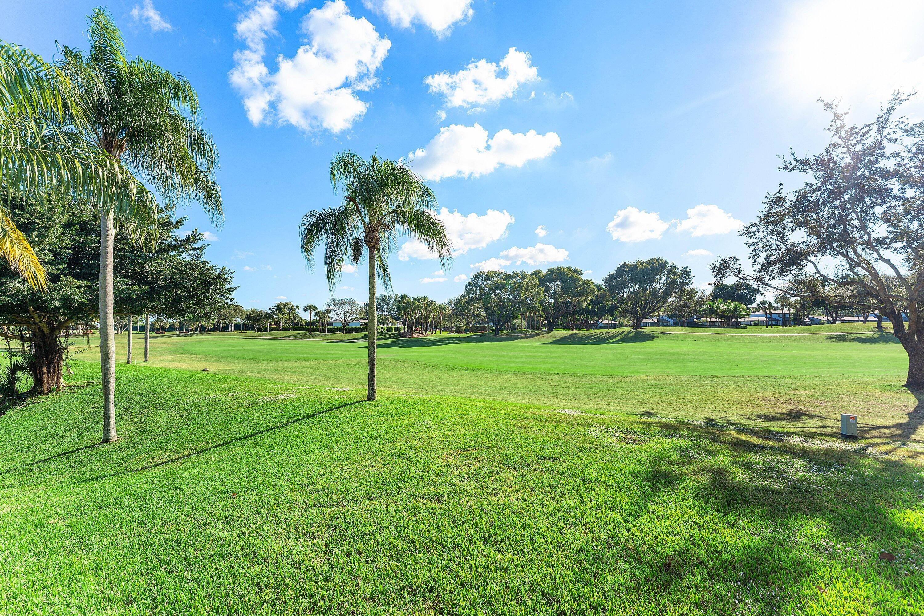 67 Eastgate Drive, Unit C Boynton Beach, FL 33436 - Photo 40 of 62 a view of a golf course with a lake