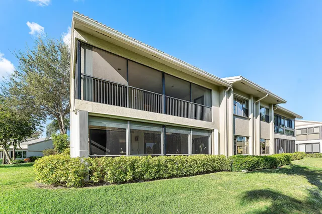 a living room filled with furniture and a large window