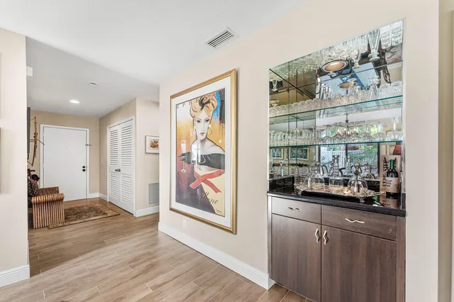 a view of a dining room with furniture large windows and wooden floor