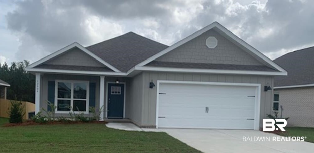 12904 Grand Rpds Road Fairhope, AL 36532 - Photo 2 of 34 View of front of house with a garage and a front yard