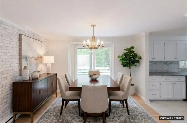 a dining room with furniture window and wooden floor