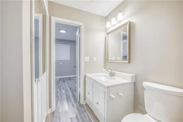 a view of a room with wooden floor and white walls