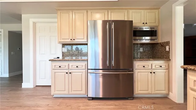 a kitchen with stainless steel appliances white cabinets and a refrigerator