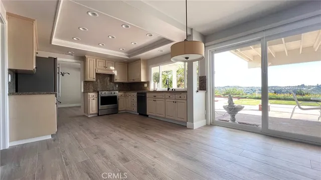 a view of a kitchen with a stove cabinets and wooden floor