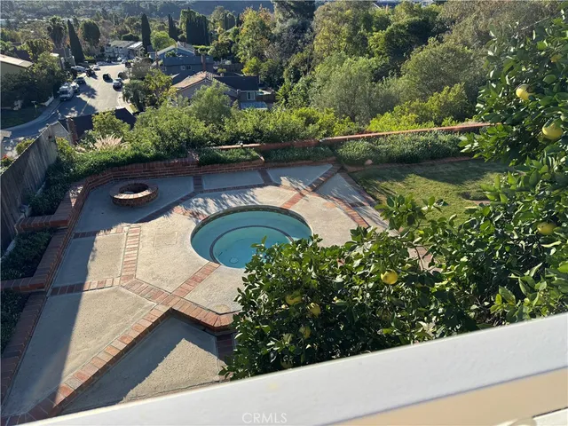 an aerial view of a house with a yard and lake view