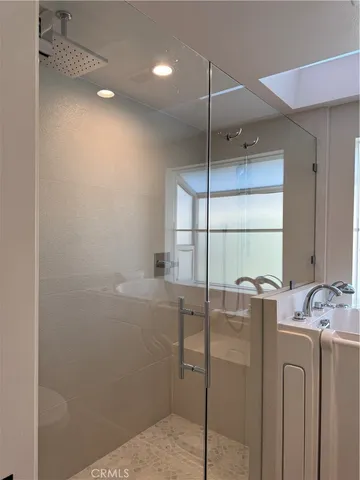 a bathroom with a window and a shower