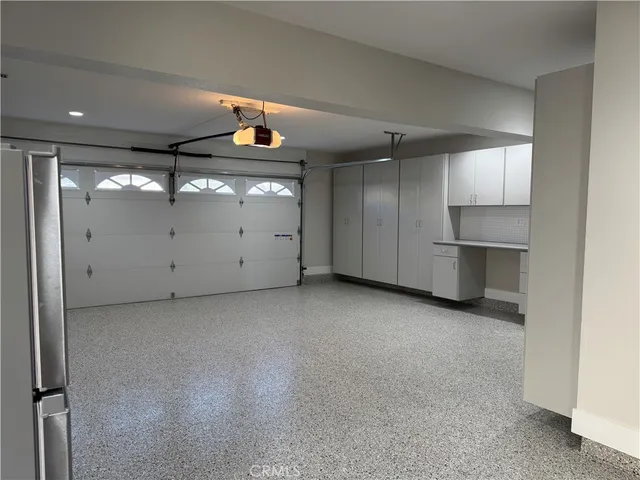 a utility room with refrigerator and washer