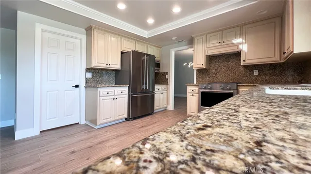 a kitchen with stainless steel appliances granite countertop a refrigerator sink and cabinets
